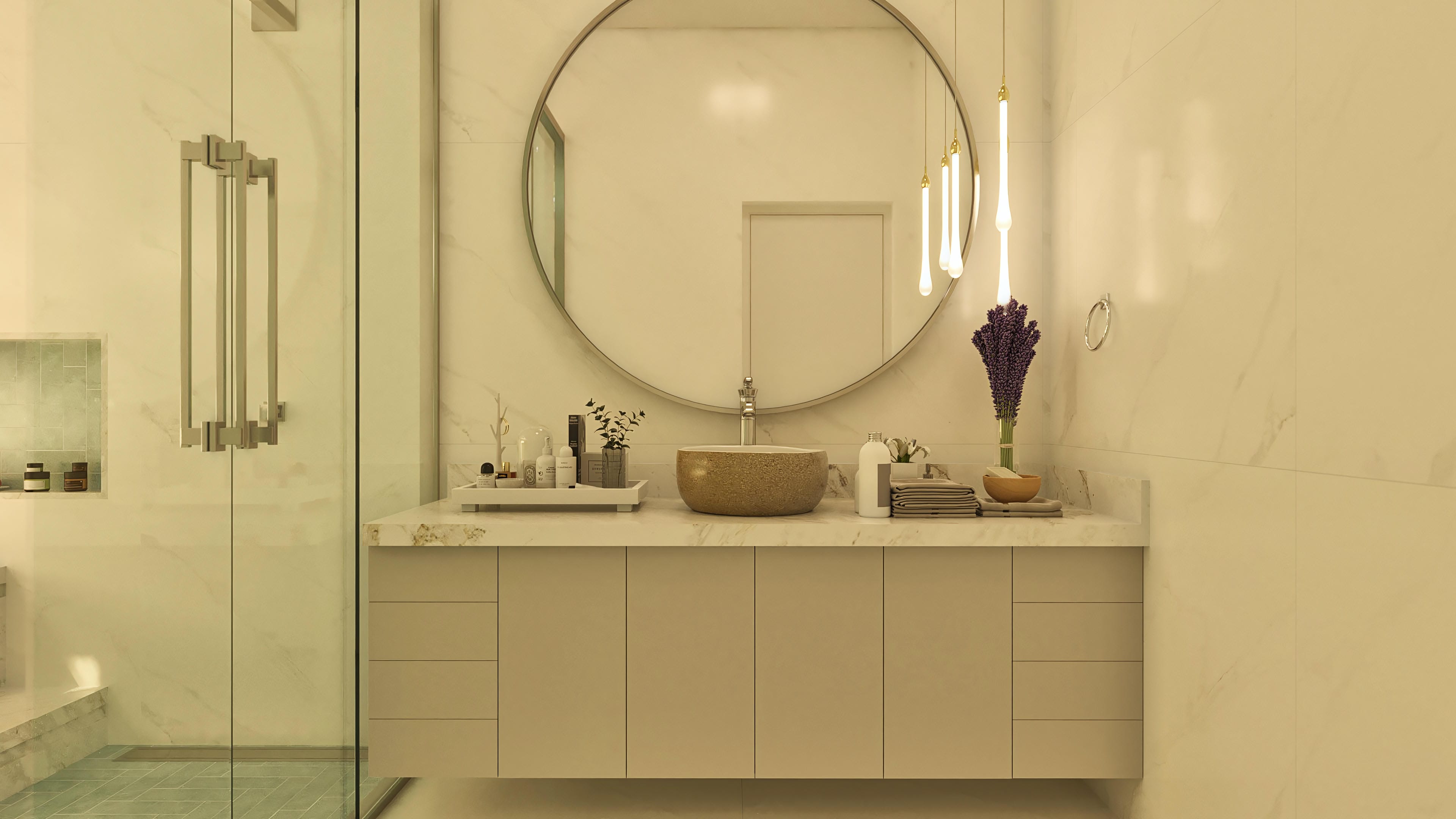 Interior of a modern bathroom with marble countertop, sculpted sink, planned cabinet, round mirror, pendant lighting, and tempered glass shower enclosure.