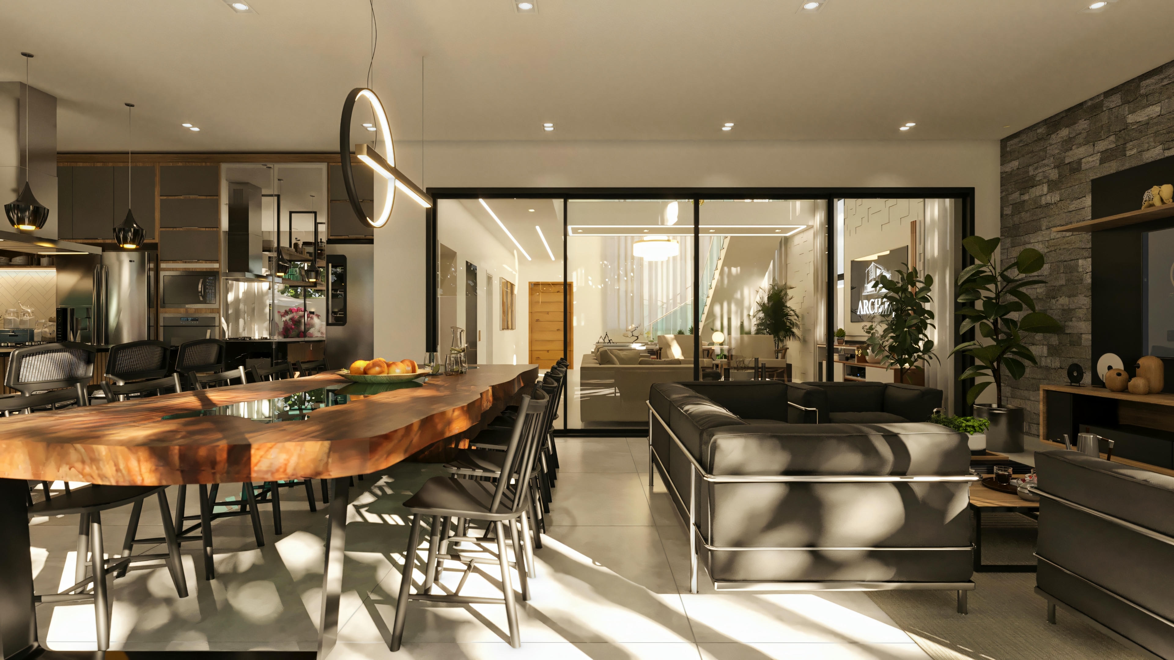 Overall view of the open-concept social area in the high-standard 5-suite house, displaying the integration between living/TV room, dining room with rustic wood table, and kitchen/gourmet area in the background.