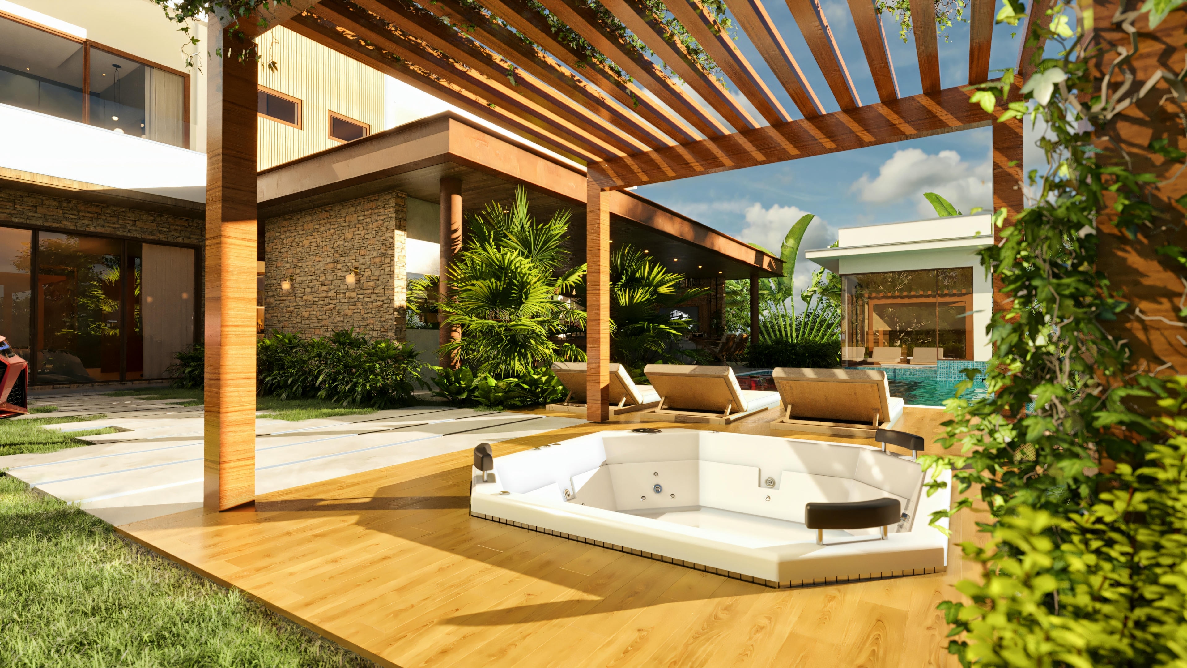 White jacuzzi installed on a wooden deck under a pergola covered with vegetation, with sun loungers and a pool in the background, in the leisure area of a luxury house.