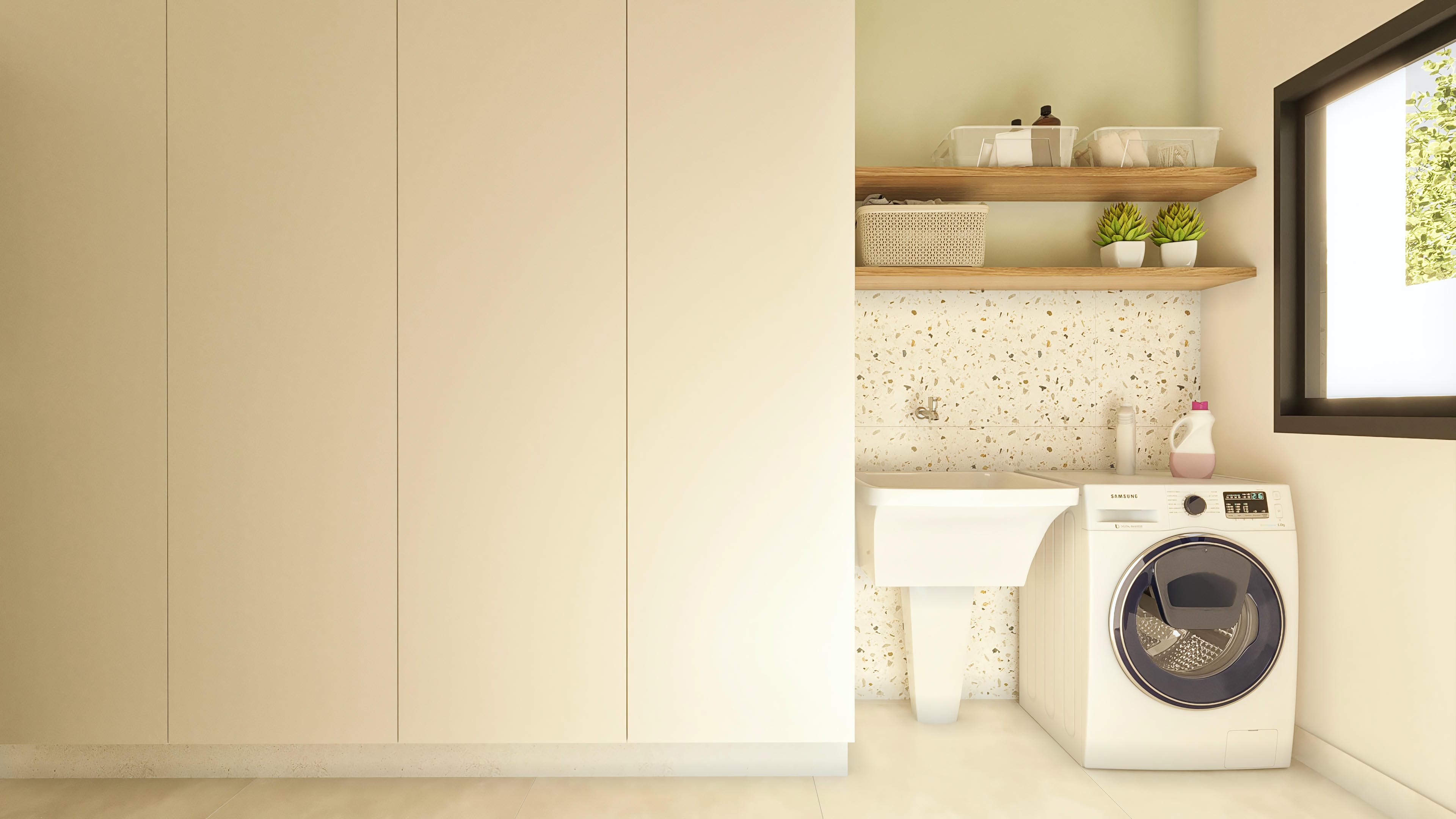 Modern laundry room with custom white cabinets, countertop with built-in sink, front-loading washing machine, and niche with wooden shelves and terrazzo details.
