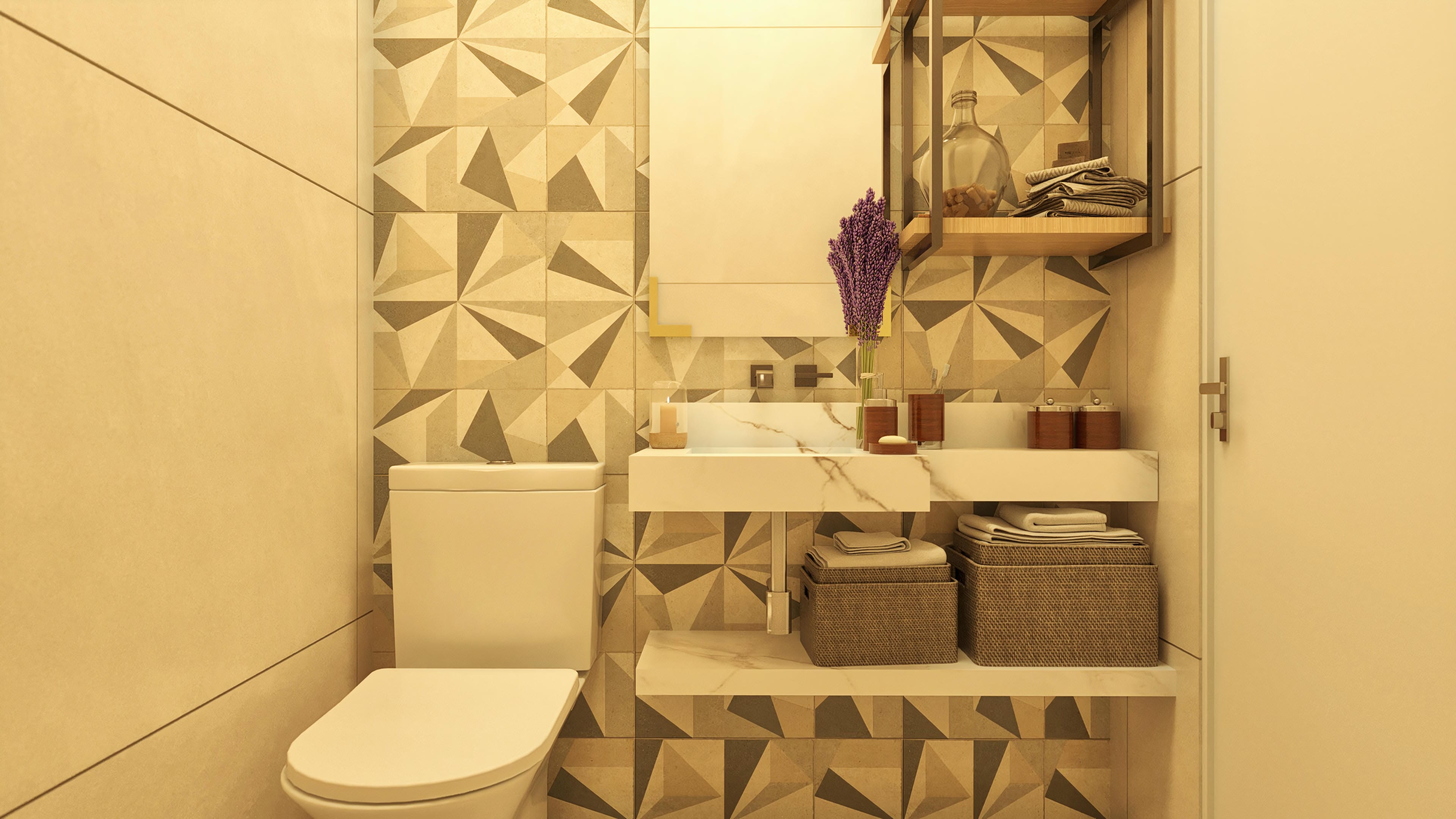 Detail of a modern bathroom with geometric tiling in shades of beige and gray, marble vessel sink, and gold-framed mirror.
