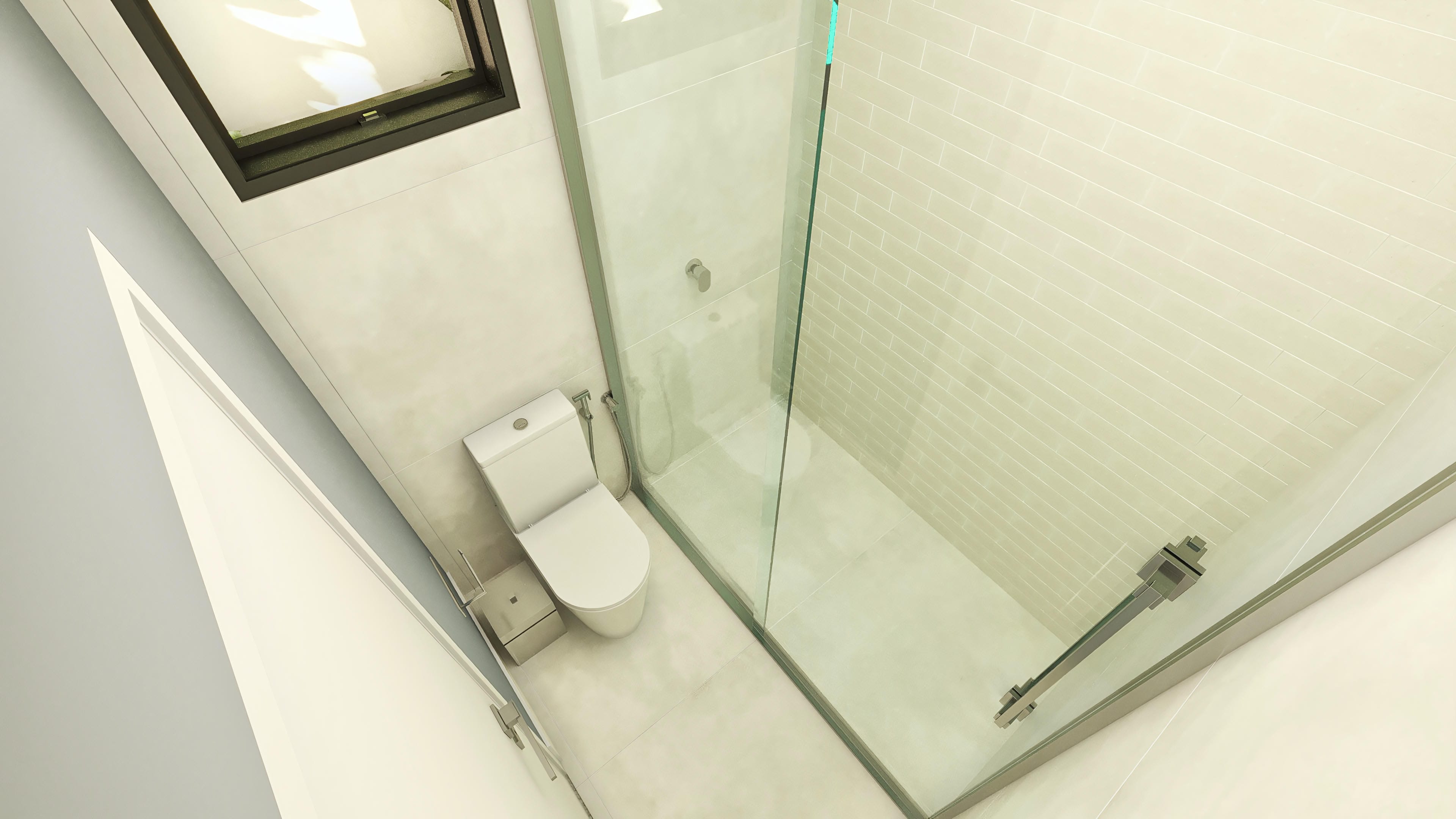 Detalle de un baño moderno con inodoro, mampara de cristal templado y revestimiento en tonos claros, integrando funcionalidad y sofisticación.