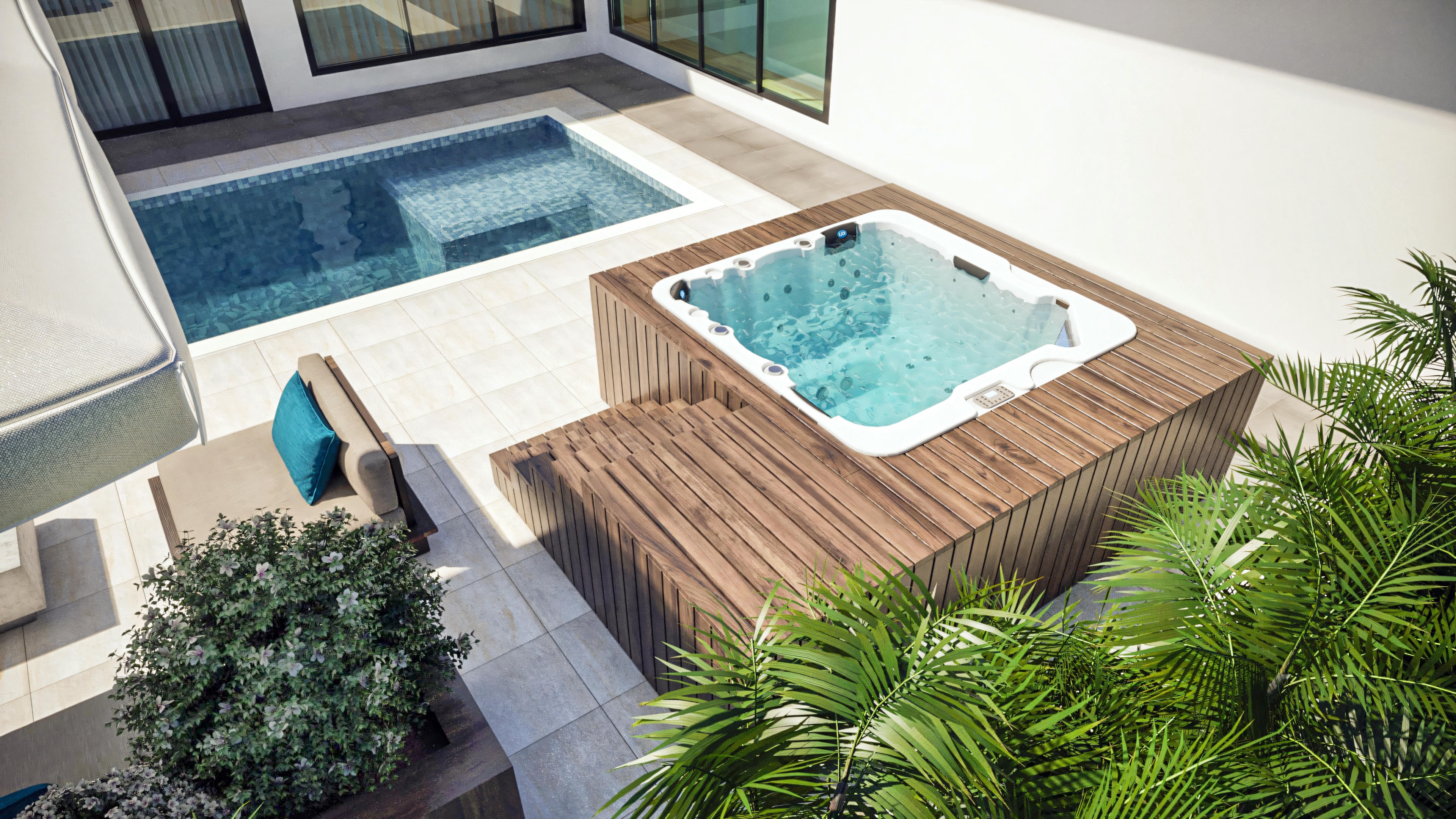 Vista superior de la jacuzzi con terraza de madera y escalones, junto a la piscina, en zona de ocio de casa de planta baja con 3 suites y zona gourmet.