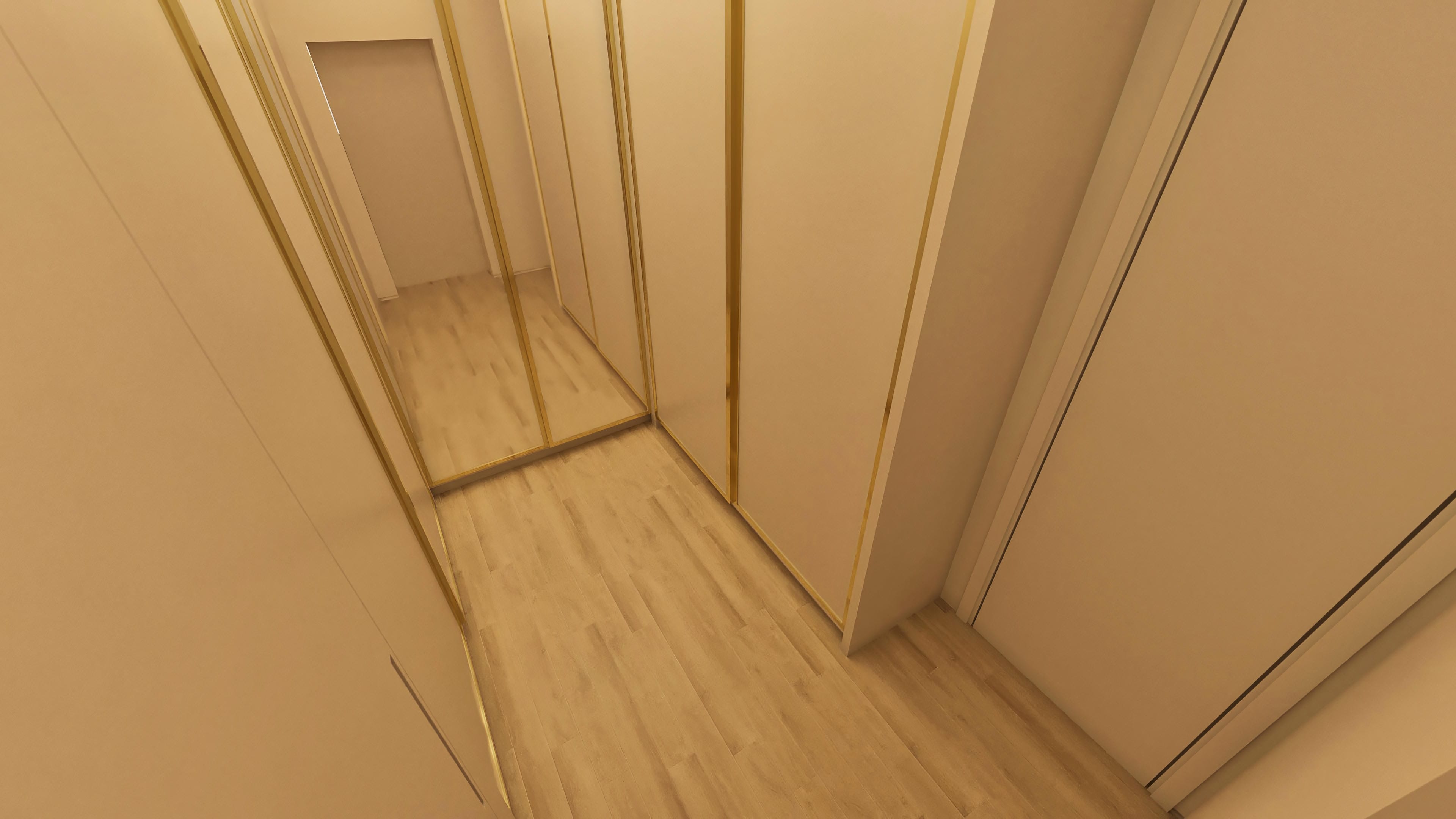 Interior of a luxurious closet with recessed lighting, cabinets with golden details, and light wood floor.