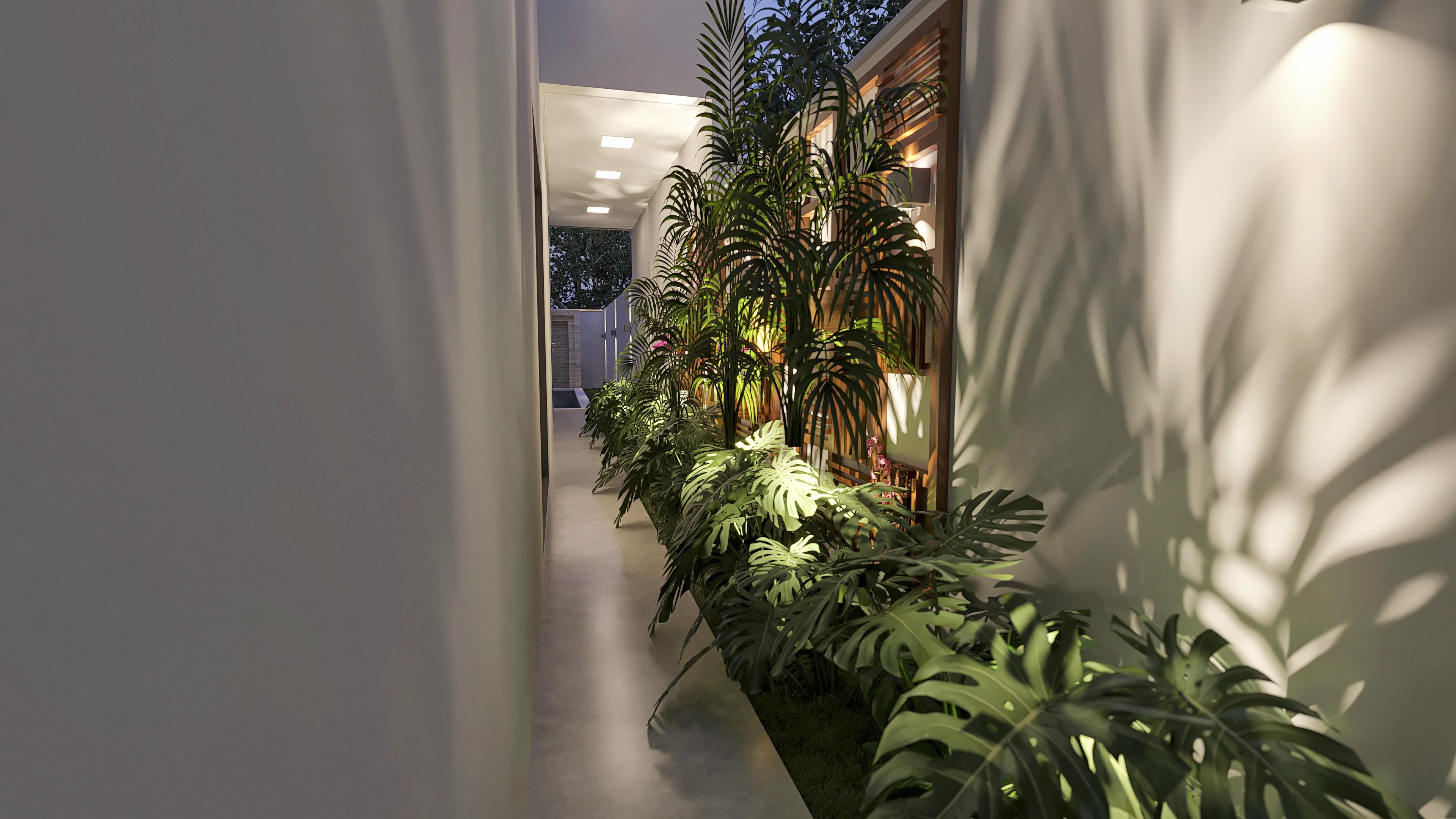 External hallway with built-in ceiling and wall lighting, lush landscaping with foliage, and slatted wood details, creating a modern and inviting environment.