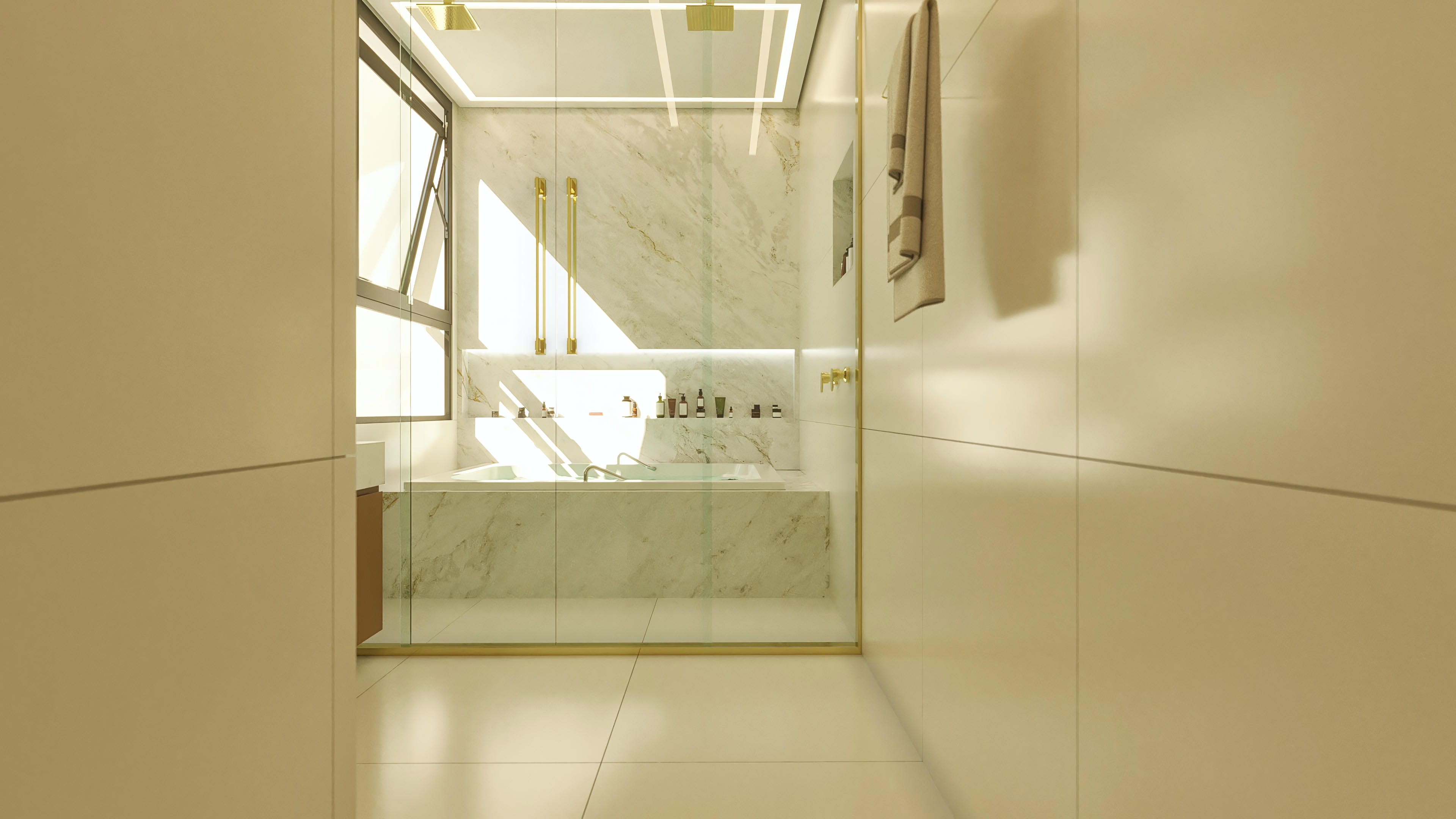Interior de um banheiro luxuoso, destacando uma banheira com revestimento em mármore e metais dourados, além de uma ducha italiana com acabamentos elegantes.