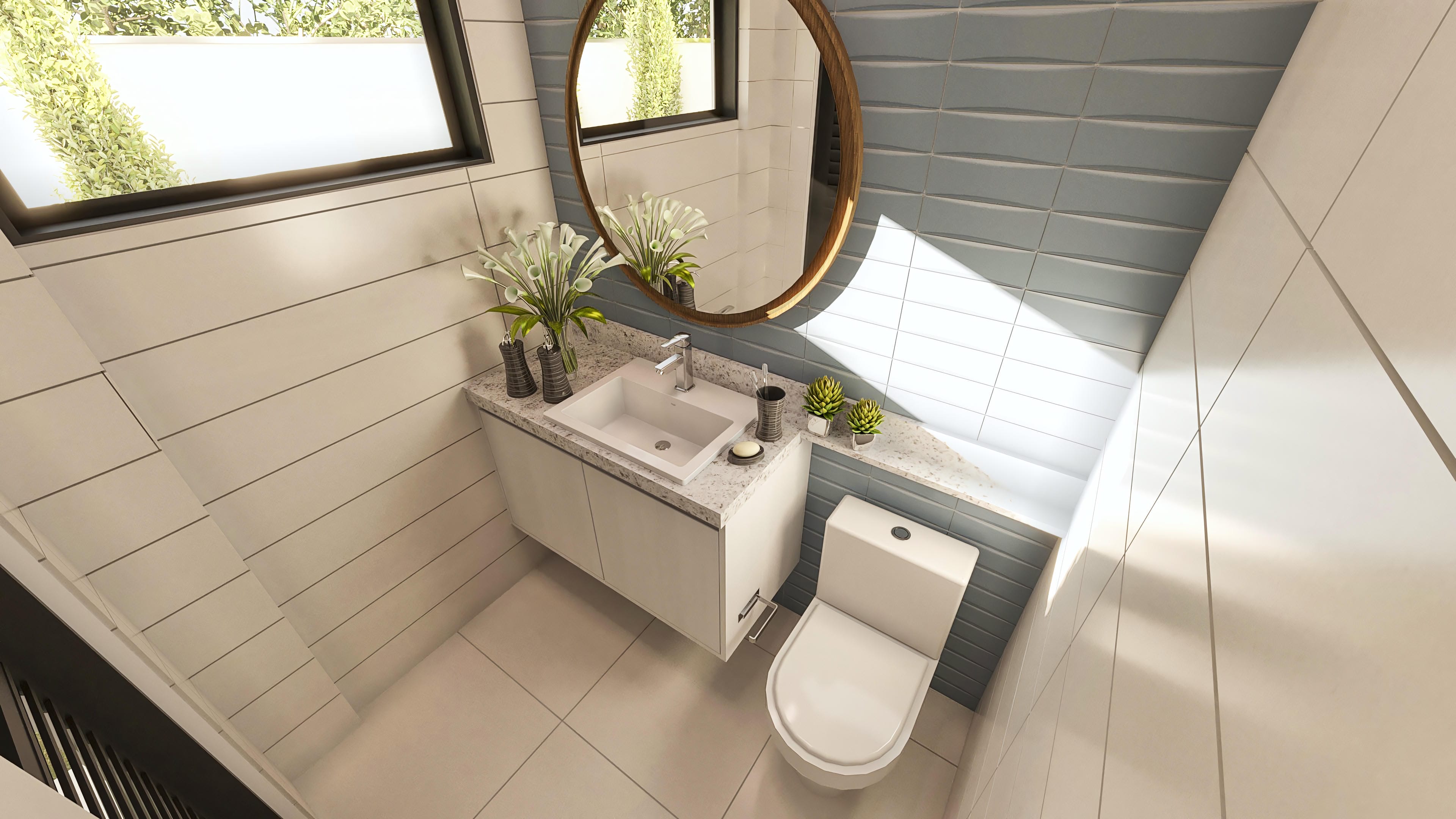 Encimera de baño con lavabo esculpido en mármol, espejo ovalado con marco de madera y revestimiento en tonos beige y azul. Detalles modernos y elegantes.