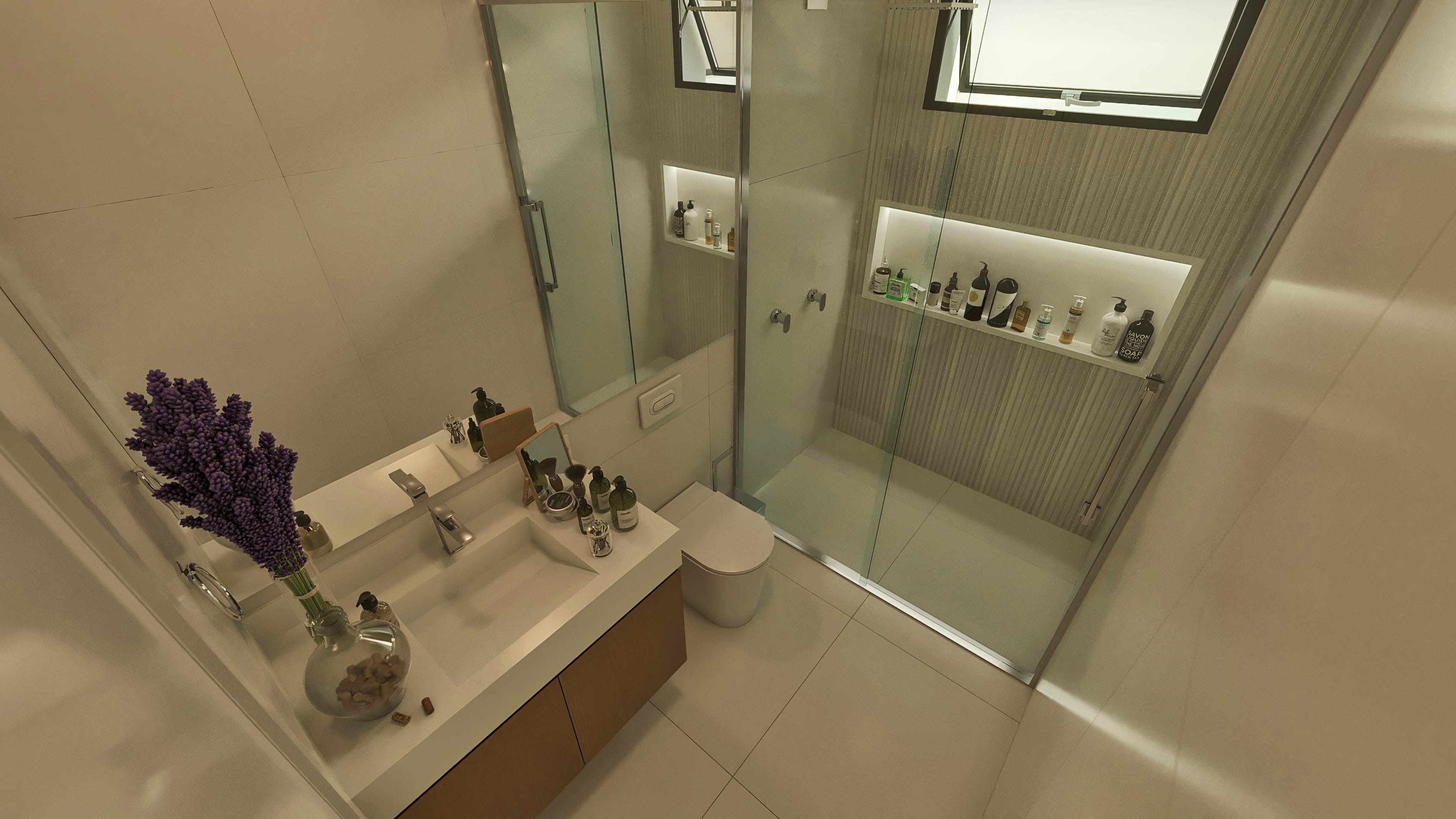 High-end bathroom with island vanity featuring a sculpted sink and modern faucet, tempered glass shower, and illuminated niches with hygiene products.