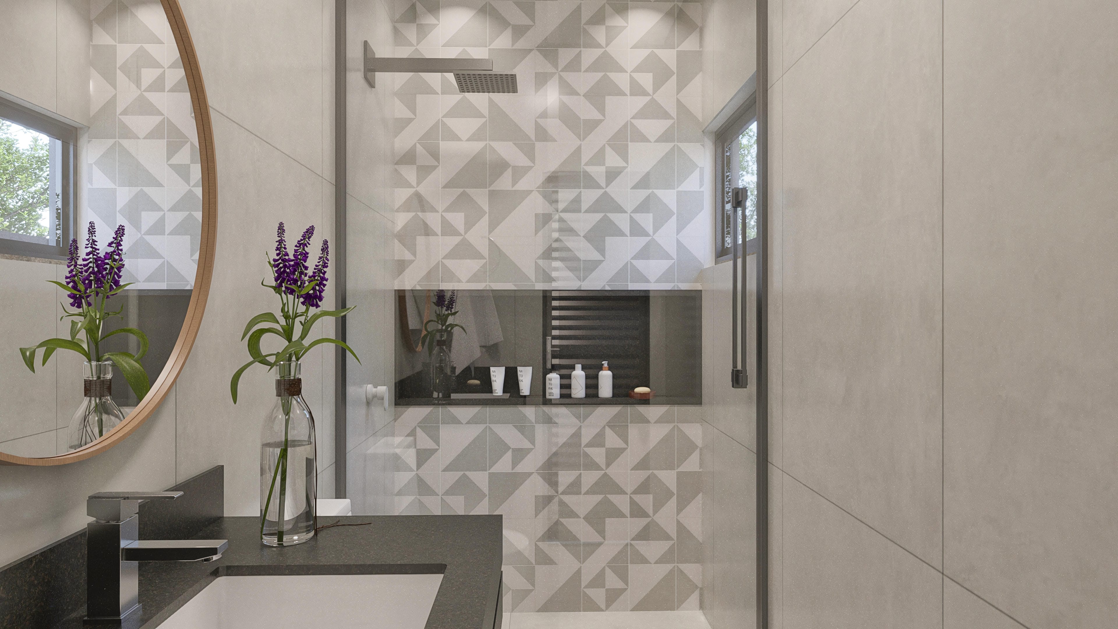 Detail of a modern bathroom with textured claddings and geometric tiles, shower stall with a showerhead, and a mirror.
