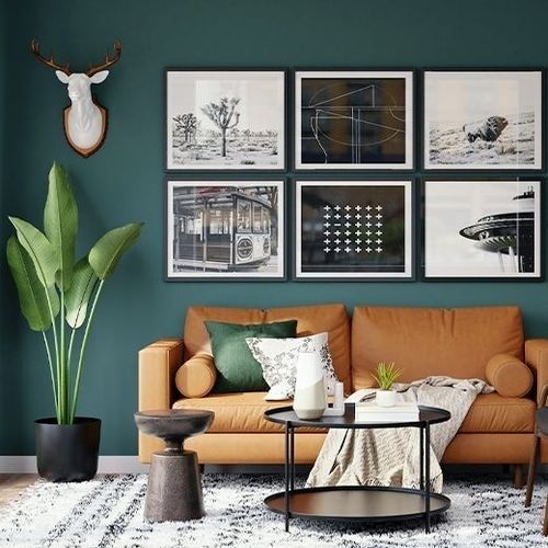 Conceptual image of applying the 60-30-10 rule in a living room environment with a brown sofa, dark green wall, and decorative paintings.