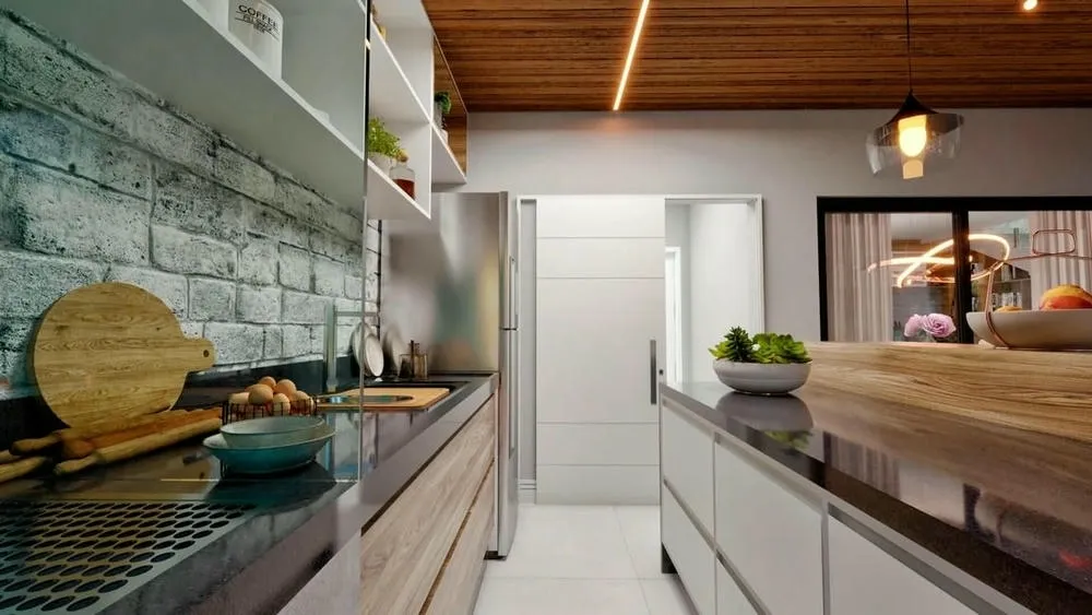 Bancada e pia de cozinha gourmet com detalhes em madeira e iluminação embutida no teto, destacando a área de preparo.