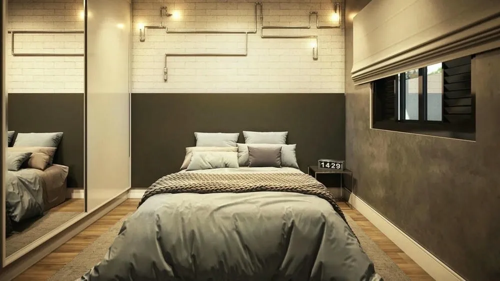 Banheiro com revestimento cinza, detalhes em preto e iluminação focada, remetendo ao estilo industrial.