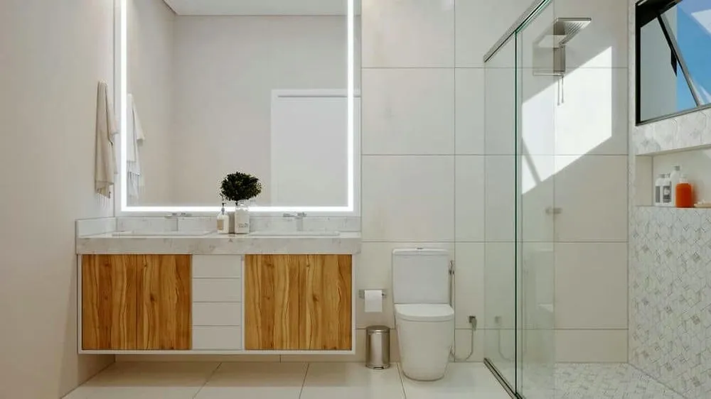 Baño con iluminación cenital y elementos naturales, creando un ambiente equilibrado y sereno, del Proyecto Finlandia.