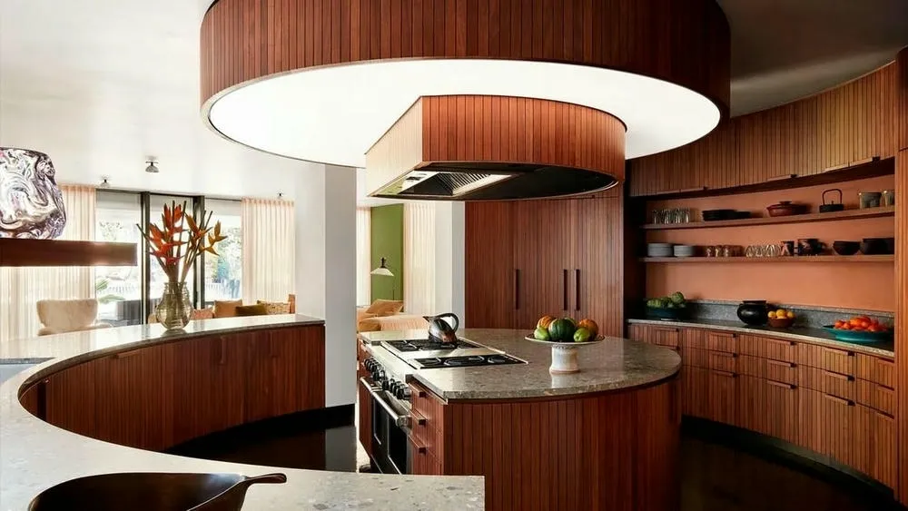 Top view of a circular kitchen with central sink and curved cabinets, highlighting the sense of balance and harmony.