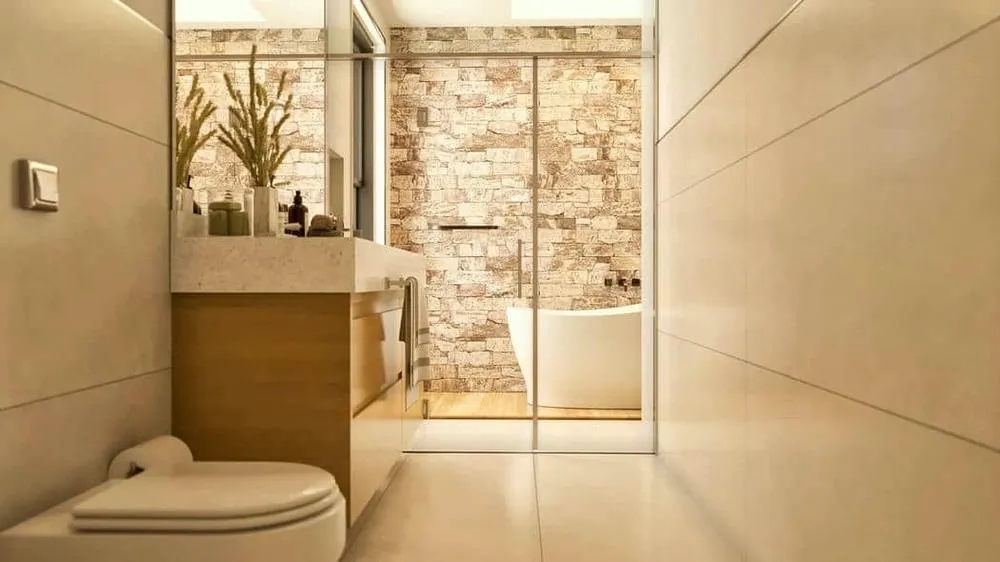 Bathroom with clean design, lots of natural light and glass shower enclosure, conveying lightness and spaciousness, from the Lyon Project.