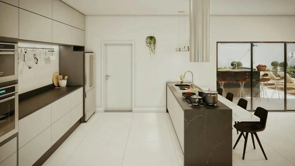 Cocina con península y taburetes, integrada a la sala de estar, promoviendo la interacción y la socialización.