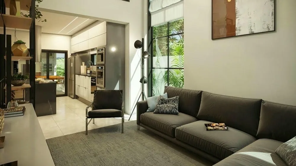 Sala de estar y cocina integradas en un ambiente de concepto abierto, demostrando el estilo industrial con grandes ventanas e iluminación natural.