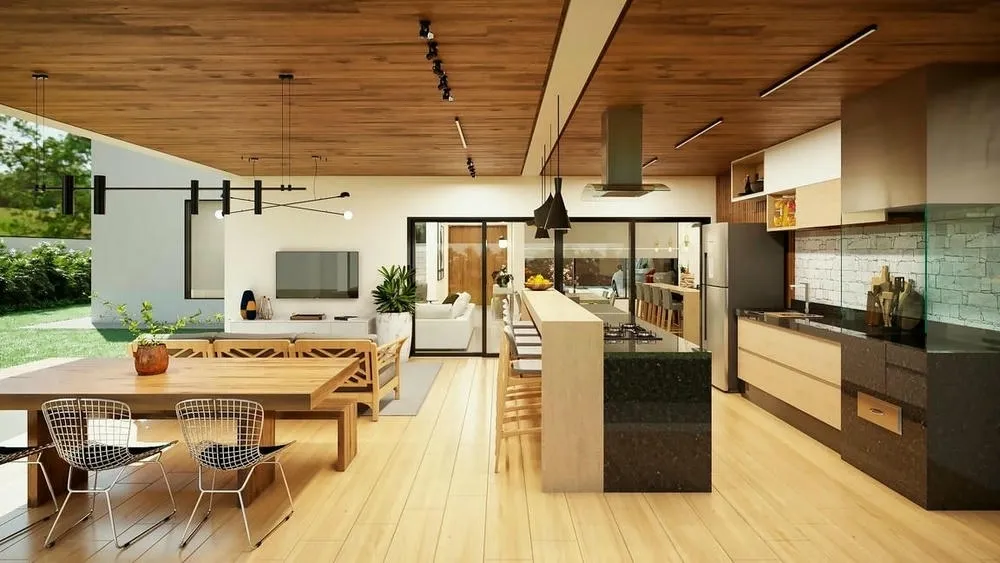 Vista amplia de un área gourmet integrada a la sala de estar, con mesa de comedor y encimera, realzando el concepto abierto.