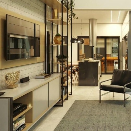 Imagem de um espaço de convivência moderno e integrado, com sala de estar, sala de jantar e cozinha, decorado com móveis sofisticados e iluminação aconchegante.