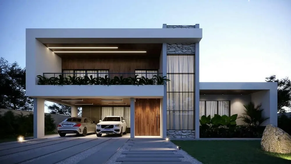 Fachada de casa con rasgos modernos y revestimientos rústicos, combinando diferentes texturas y estilos de forma armoniosa.