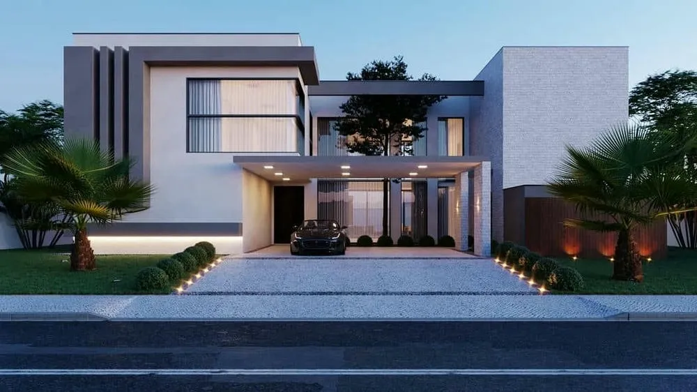 Front facade of a modern luxury house with volumetry and recessed lighting.