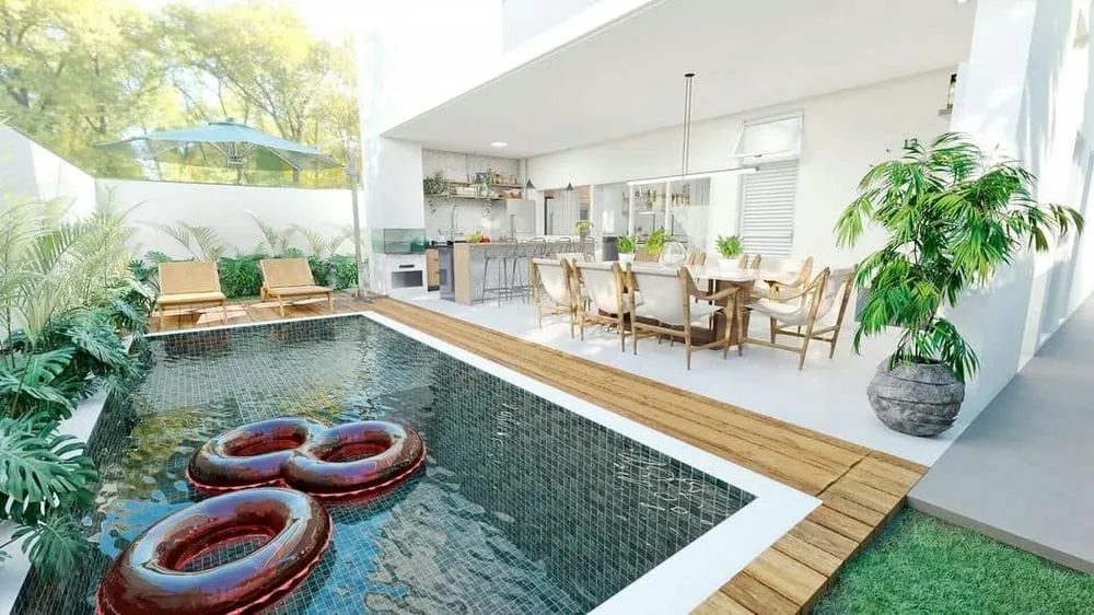 Gourmet space integrated into the pool in a compact area, optimizing leisure in small spaces.