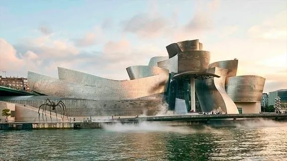 Guggenheim Museum Bilbao, with its curvilinear shape and titanium facade, a landmark of global contemporary architecture.