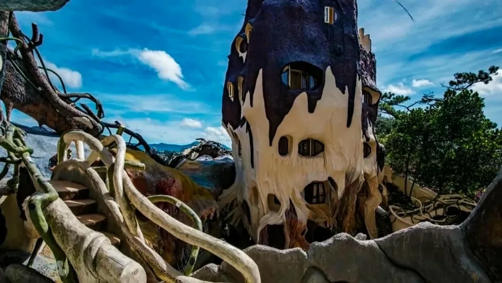 Exterior facade of Hang Nga Guesthouse in Vietnam, known as 'Crazy House', with extravagant shapes.