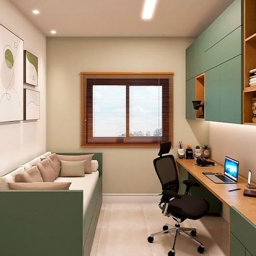 Home office pequeño con paredes claras, sofá verde y mesa de madera, con una ventana que brinda luz natural.