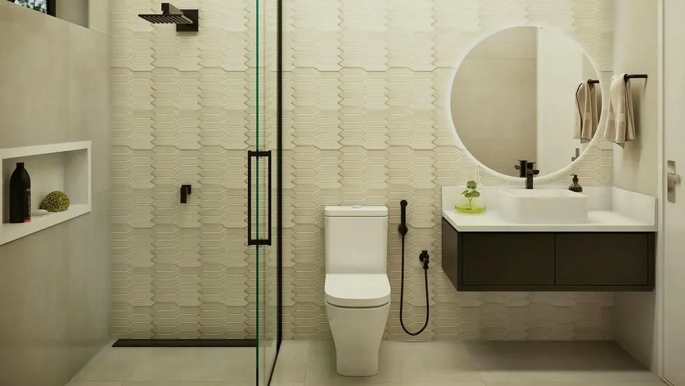Baño moderno con iluminación destacada sobre el lavabo y espejo redondo, realzando la zona.