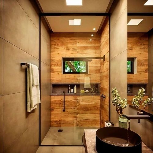 A modern bathroom with industrial style elements, including concrete walls, wooden details and recessed lighting.