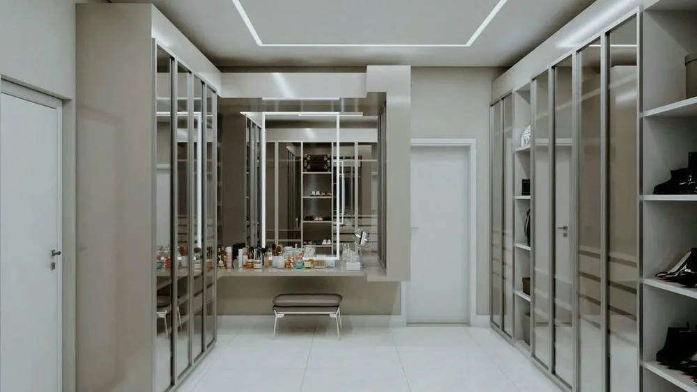 Large closet with glass cabinets and central mirror, providing a spacious and luxurious environment.