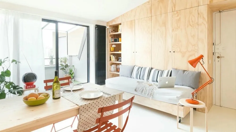 Environment with light walls and neutral-toned furniture, conveying a sense of spaciousness in a small space.