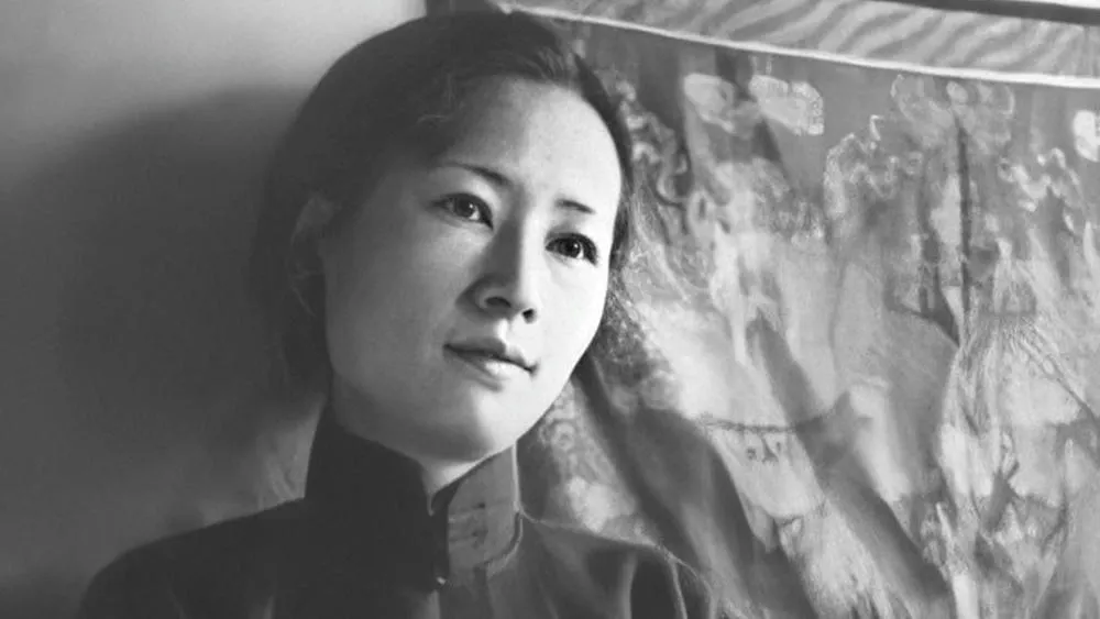 Black and white portrait of Lin Huiyin, with an abstract pattern in the background.