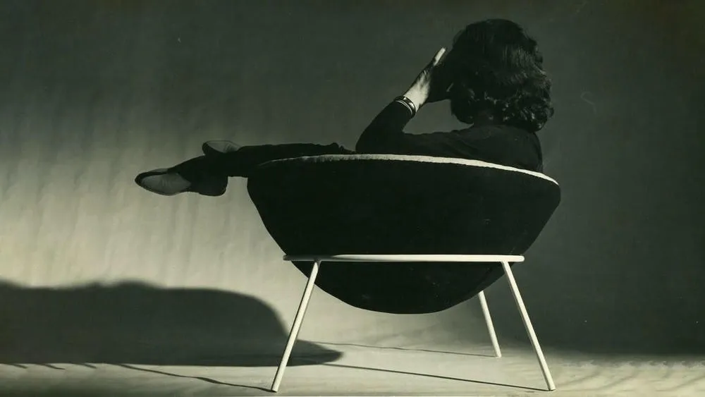 The Bowl Armchair, an iconic furniture piece by Lina Bo Bardi, with its modern and curved design.
