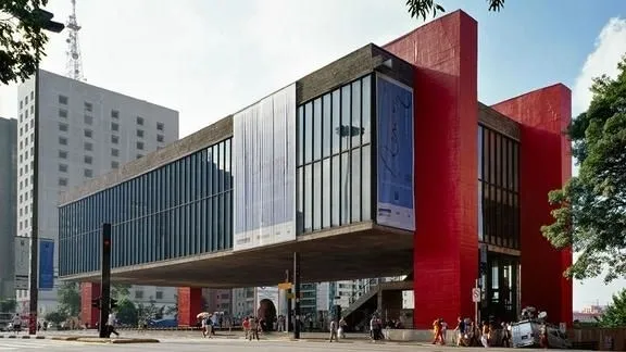 Building with glass facade and exposed structure, characteristic of modern architecture.