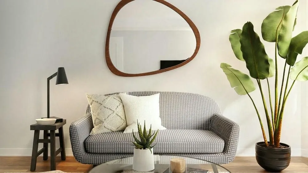 Living room with light sofa, coffee table, and plants, demonstrating how to use furniture that can be transported in a rented house.