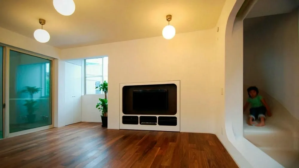 Interior of Slide House, showing the slide as a central element and multiple levels.