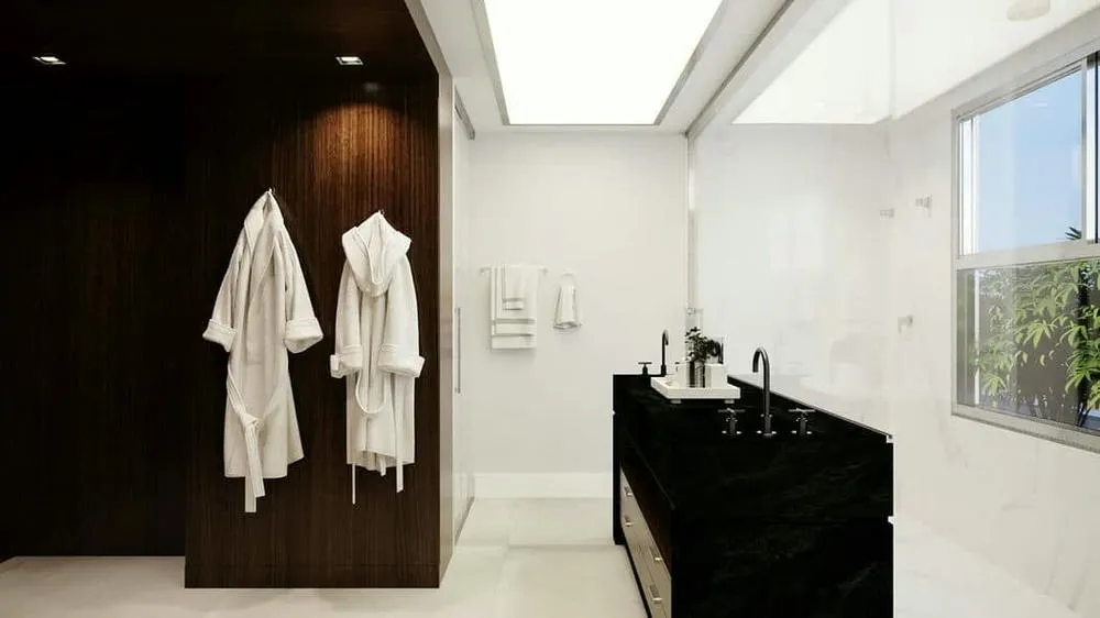 Sophisticated bathroom with planned lighting, large mirror, and modern coverings, from the Madagascar Project.