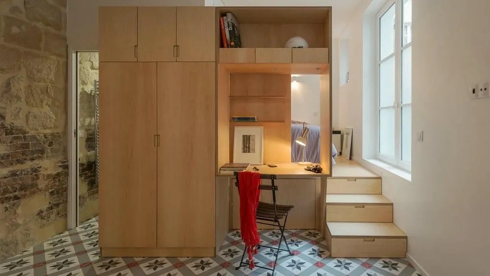 Organized home office with shelves and compact desk, illustrating the importance of organization in small spaces.