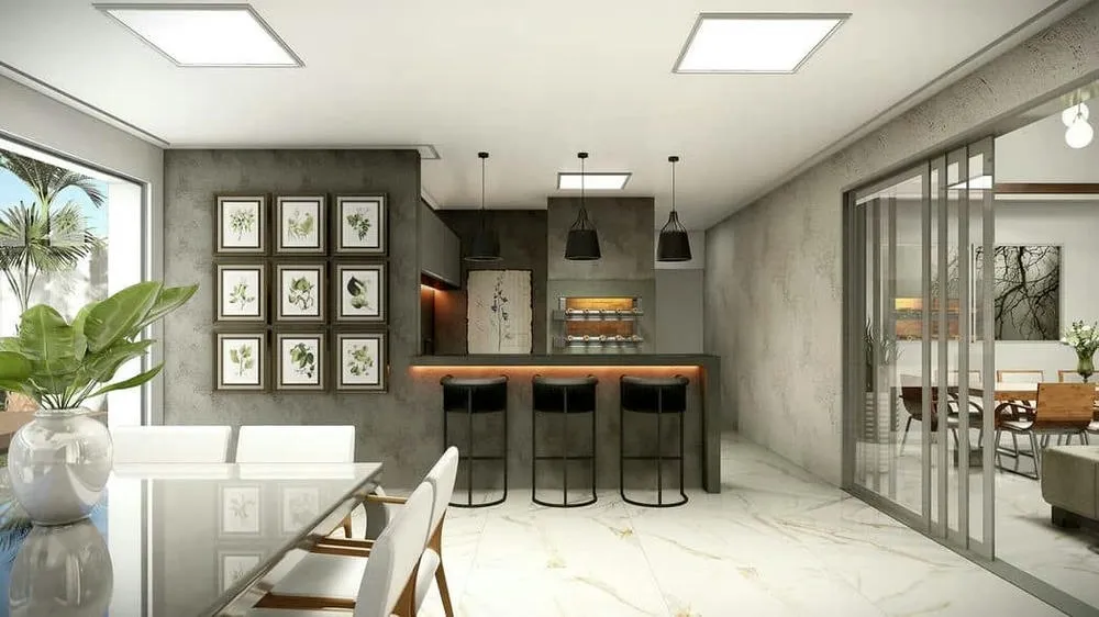 Spacious outdoor gourmet area with sophisticated design and pool, ideal for leisure.