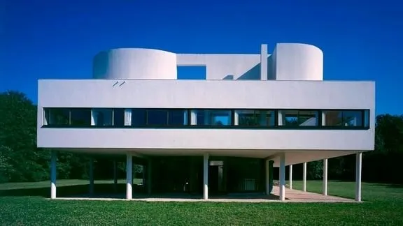 Le Corbusier's Villa Savoye, with its cubic shape and integration with nature, an example of modern architecture.